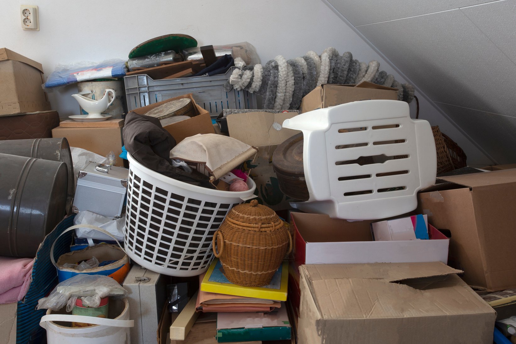 Pile of junk in a house, hoarder room pile of household equipment needs clearing out